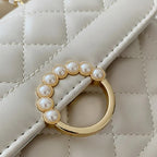 Sac à main décoré de perles et matelassé