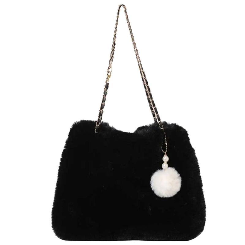 Sac à pompon en fausse fourrure porté main