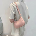 Sac baguette rose rétro en matière synthétique