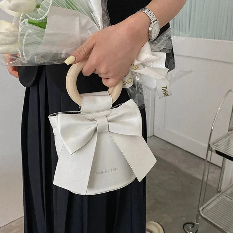 Sac femme façon bourse chic orné d’un nœud papillon