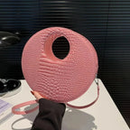 Sac rond à main avec effet crocodile