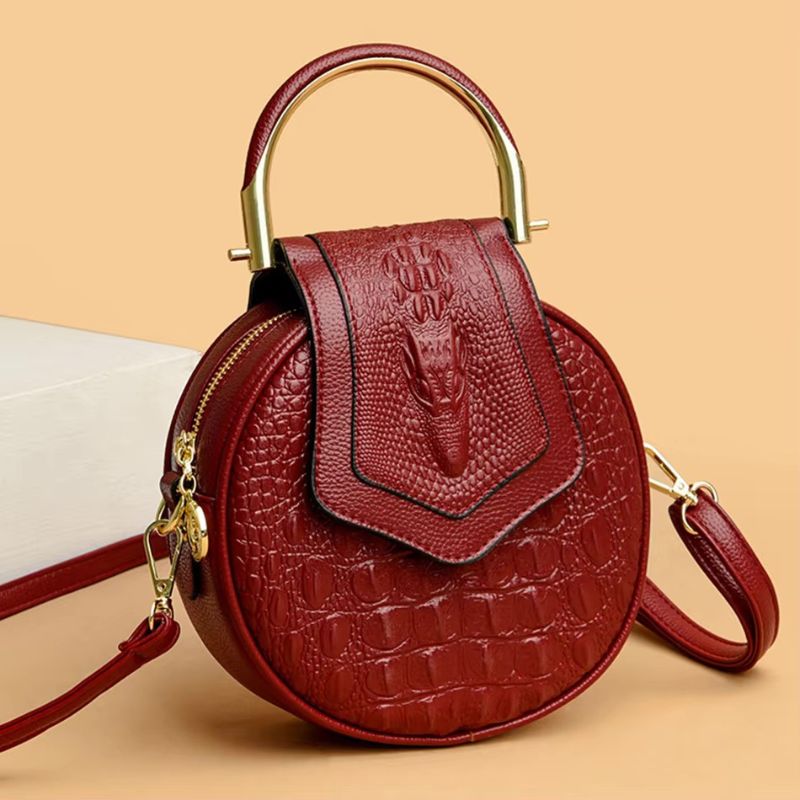 Sac rond porté main en cuir effet croco